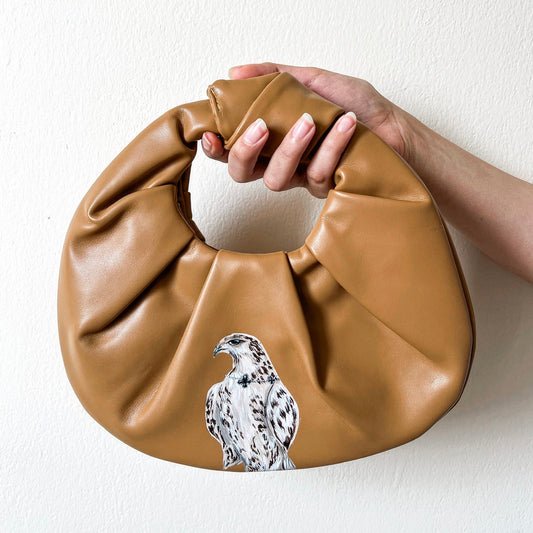 Falcon on beige folded leather hand bag